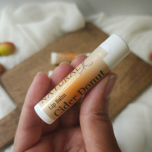 one lip balm being held to show size