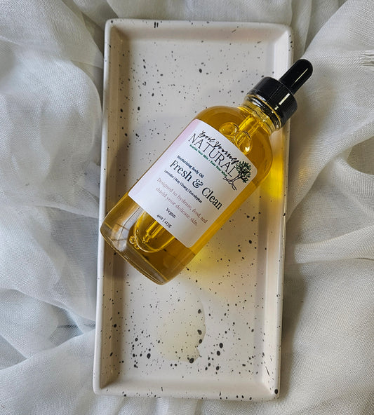 Bottle of 'Natura' fresh & clean product on a speckled tray with white fabric background