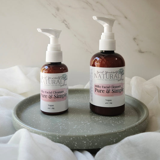 Two bottles of 'Good For You Natural' Milky Facial Cleanser on a gray tray with a marble background.