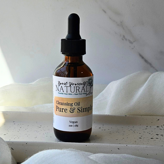 a bottle of cleansing oil in a white plate with fabric underneath