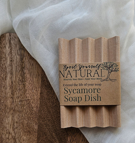 wooden soap dish on cream fabric with a label on the front