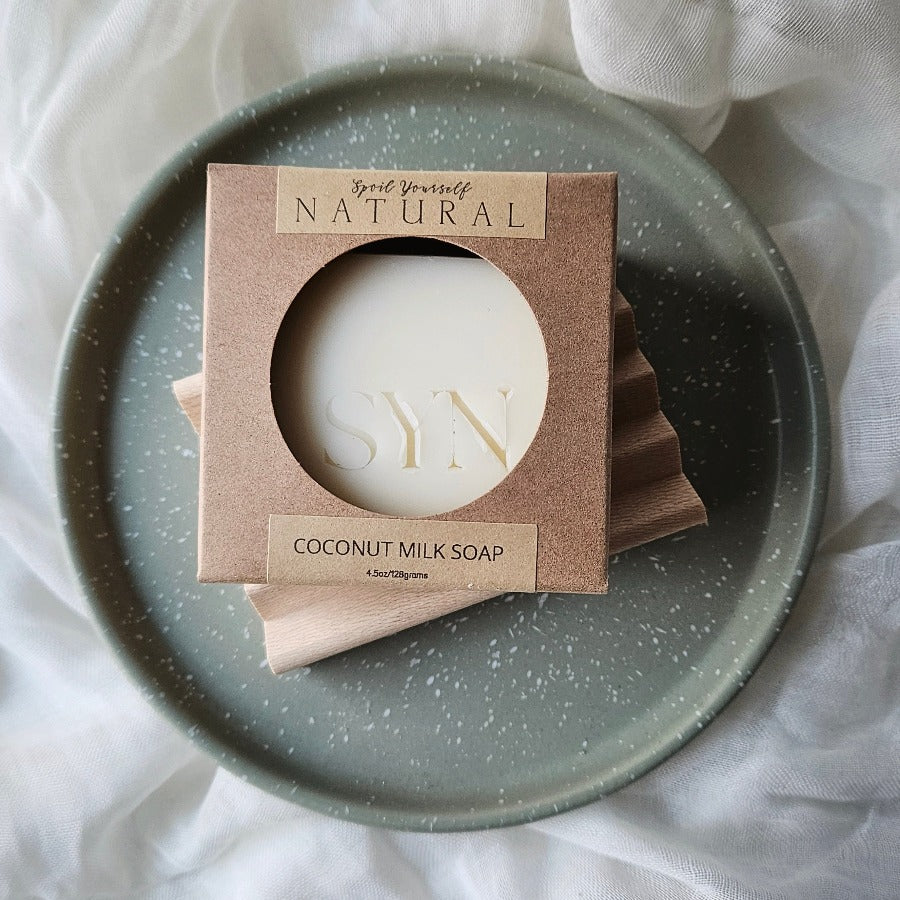 misc soap on top of a wooden soap dish as a gift set placed on a green dish