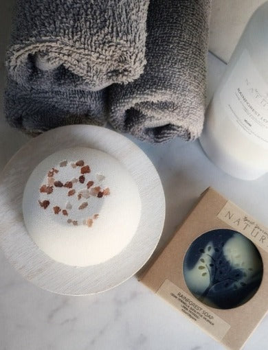 bath bomb and soap with facial towels in the background